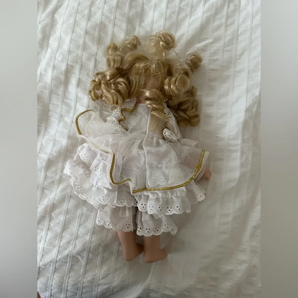 Victorian style porcelain doll with curly blond hair